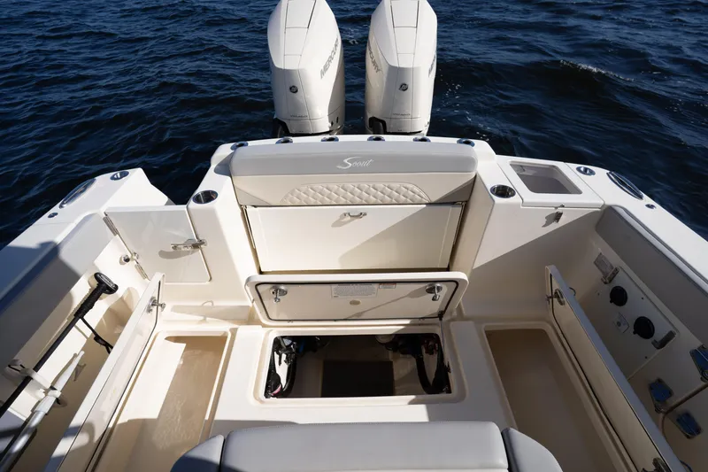 Slide: The Image of 2024 Scout 330 LXF boat deck with dual engines and storage compartments. - 39