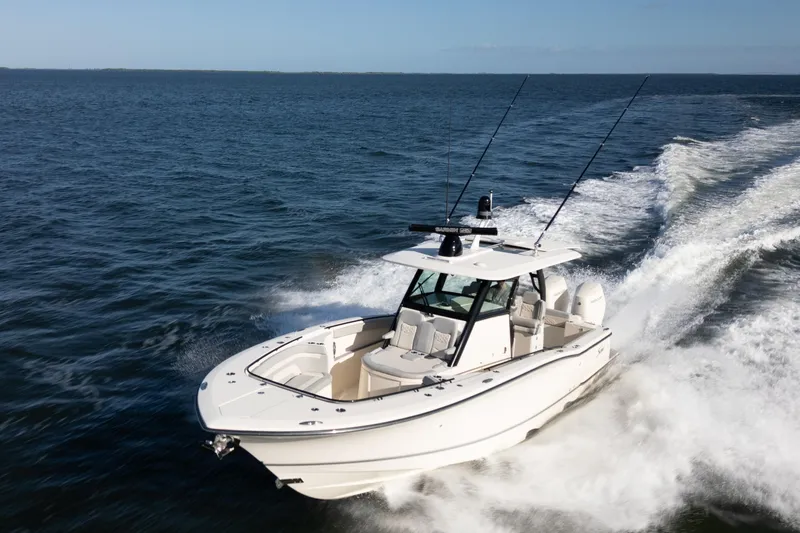 Slide: The Image of 2024 Scout 330 LXF boat cruising on open water, showcasing sleek design and performance. - 4