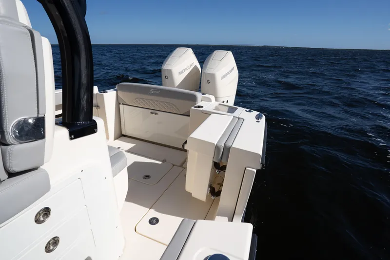 Slide: The Image of 2024 Scout 330 LXF boat with dual Mercury engines on open water. - 45