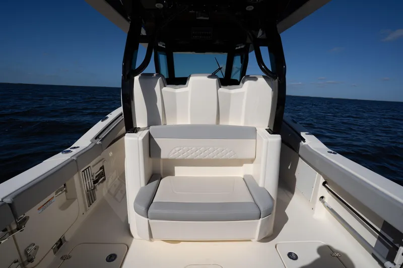 Slide: The Image of 2024 Scout 330 LXF boat interior with seating, on open water. - 53