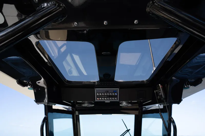 Slide: The Image of 2024 Scout 330 LXF boat interior with skylights and control panel. - 54