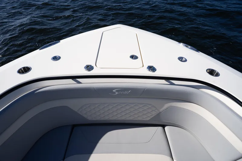 Slide: The Image of 2024 Scout 330 LXF boat bow with luxurious seating and ocean view. - 58
