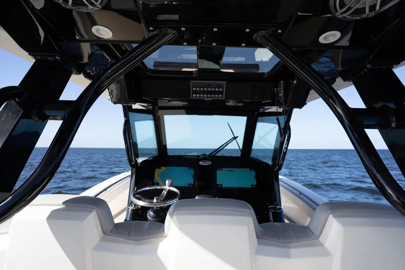 Slide: The Image of Interior view of 2024 Scout 330 LXF boat cockpit with ocean backdrop. - 61