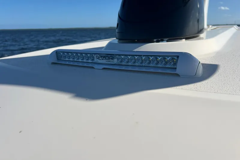 Slide: The Image of 2024 Scout 330 LXF boat with Lumitec Razor light bar on deck. - 69