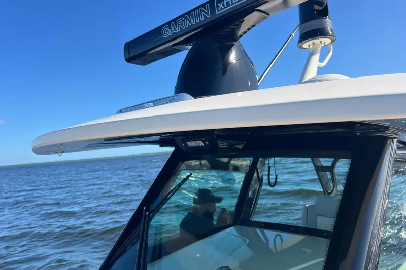 Slide: The Image of 2024 Scout 330 LXF boat with Garmin radar on open water. - 70