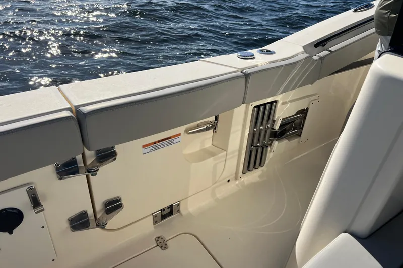 Slide: The Image of 2024 Scout 330 LXF boat interior with sleek seating and ocean view. - 74