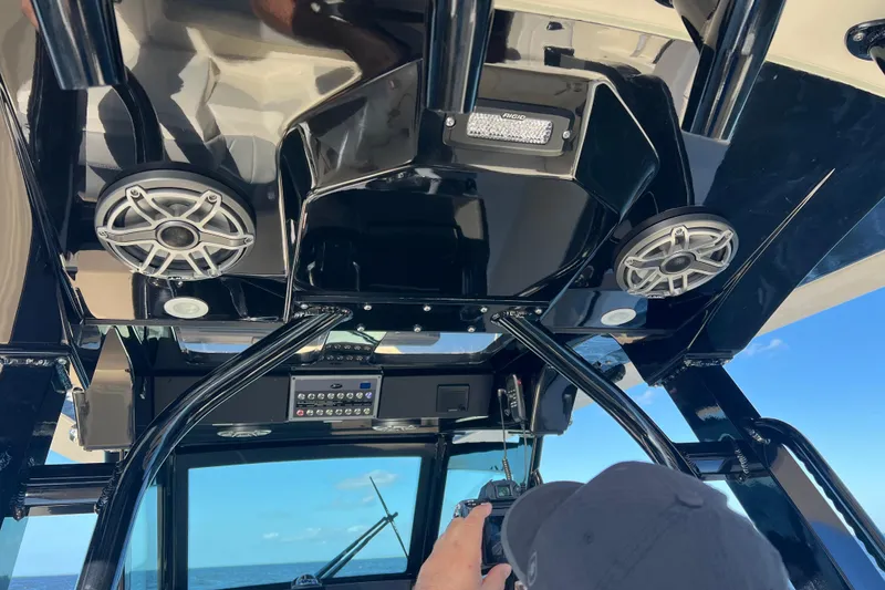 Slide: The Image of 2024 Scout 330 LXF boat interior with speakers and control panel, ocean view in background. - 76