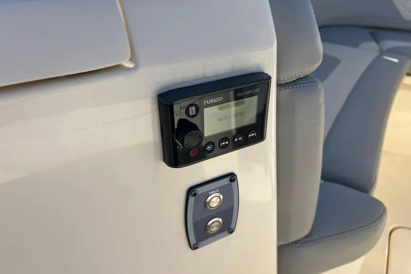 Slide: The Image of 2024 Scout 330 LXF boat featuring Fusion MS-NRX300 audio system and control panel. - 77
