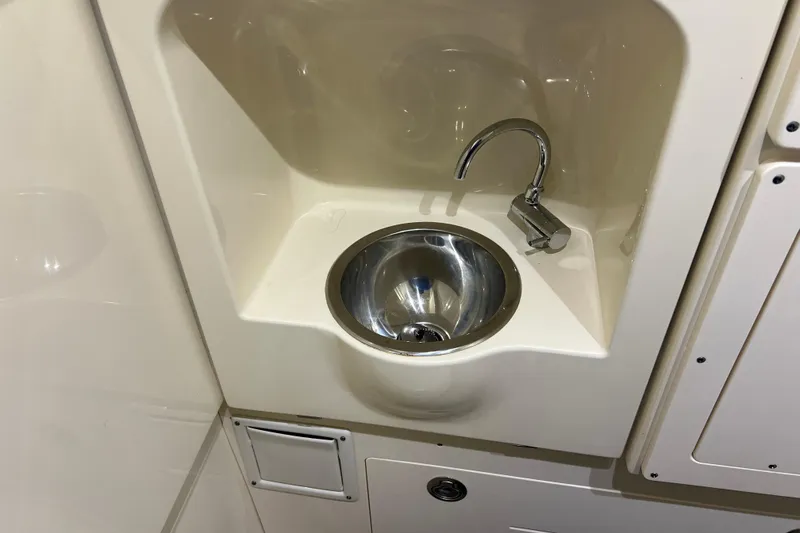 Slide: The Image of 2024 Scout 330 LXF boat interior sink with modern faucet design. - 79