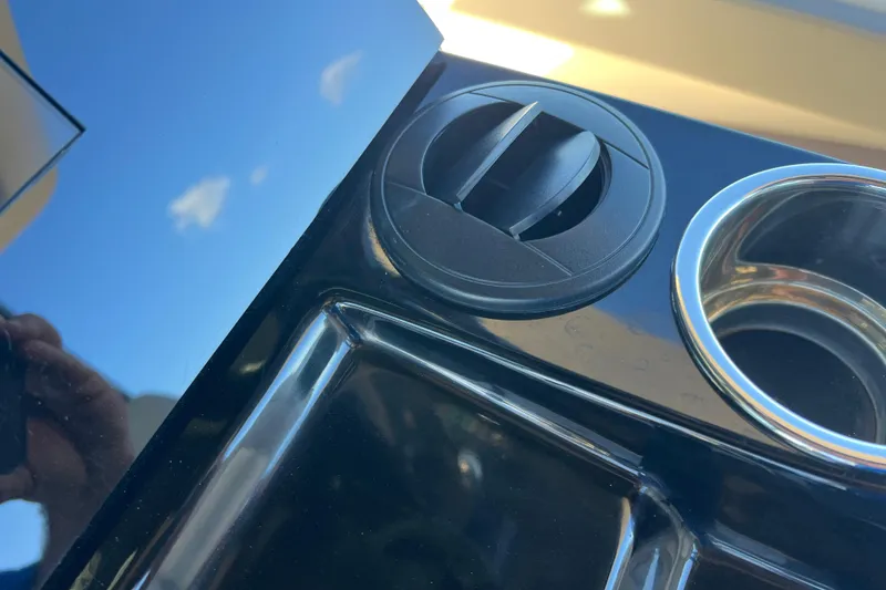 Slide: The Image of 2024 Scout 330 LXF dashboard detail with cup holder and control knob. - 87