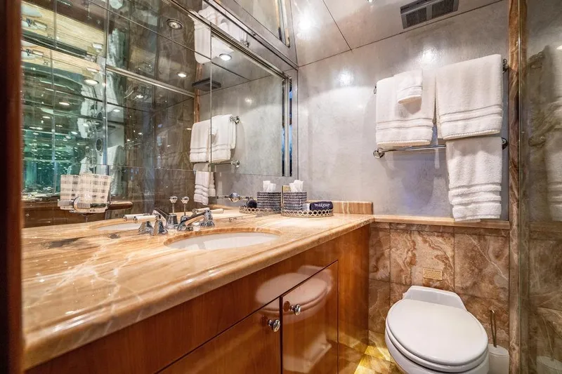 Slide: The Image of Luxurious bathroom on 2003 Hatteras 75' Cockpit MY yacht with marble countertop and elegant fixtures. - 14