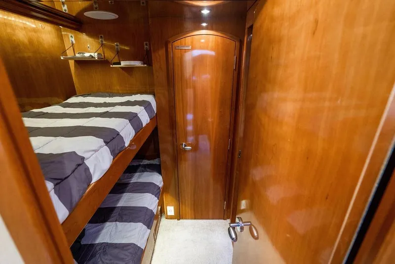Slide: The Image of Interior of 2003 Hatteras 75' Cockpit MY with wooden bunk beds and door. - 18
