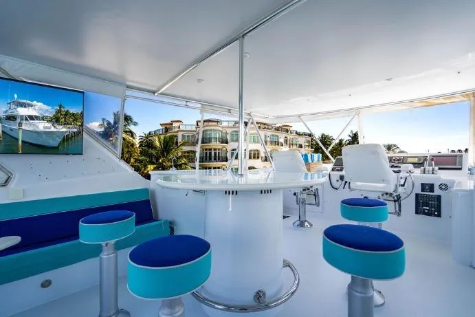 Slide: The Image of Luxurious 2003 Hatteras 75' Cockpit MY yacht interior with modern seating and ocean view. - 20