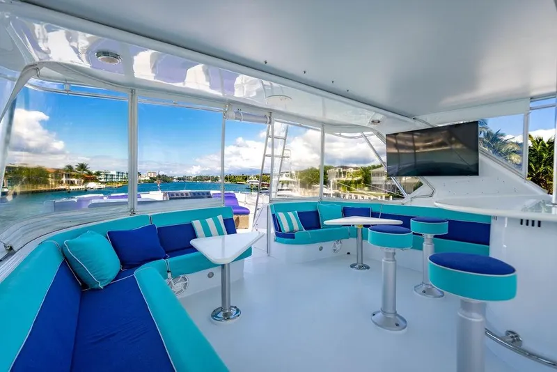 Slide: The Image of Luxurious 2003 Hatteras 75' Cockpit MY yacht interior with vibrant seating and scenic views. - 22