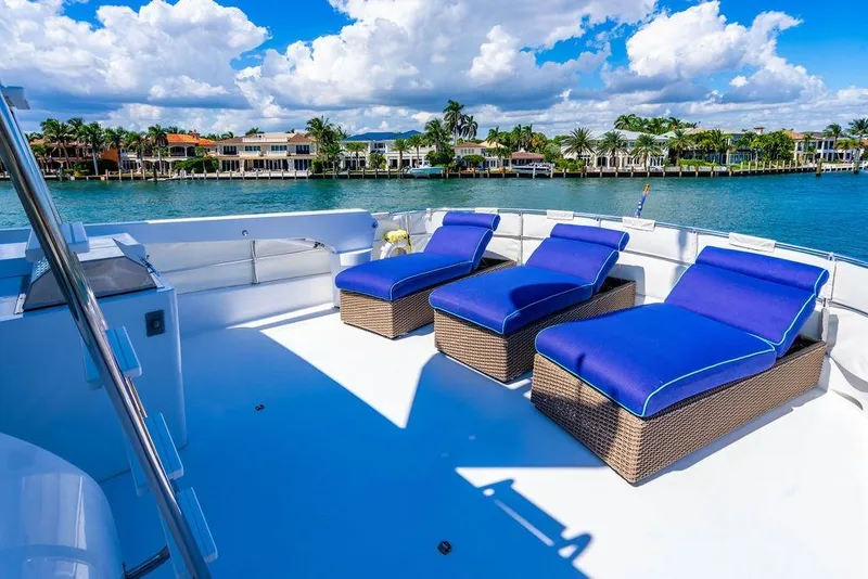 Slide: The Image of Luxurious 2003 Hatteras 75' Cockpit MY yacht with blue sun loungers on deck. - 23