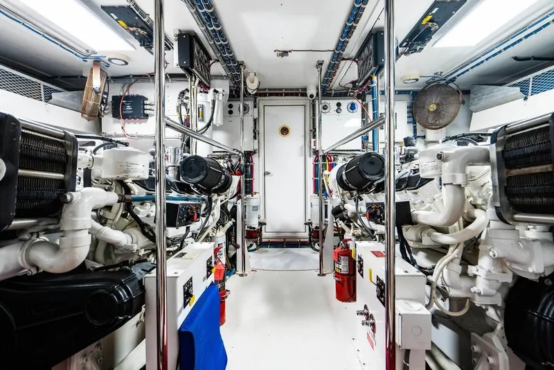 Slide: The Image of Engine room of 2003 Hatteras 75' Cockpit MY yacht, featuring dual engines and equipment. - 28