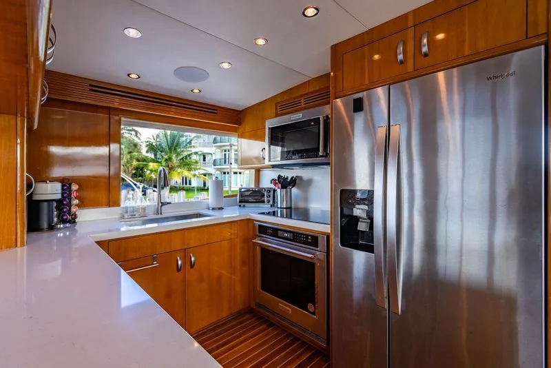Slide: The Image of Luxurious kitchen interior on 2003 Hatteras 75' Cockpit MY yacht, featuring modern appliances. - 5
