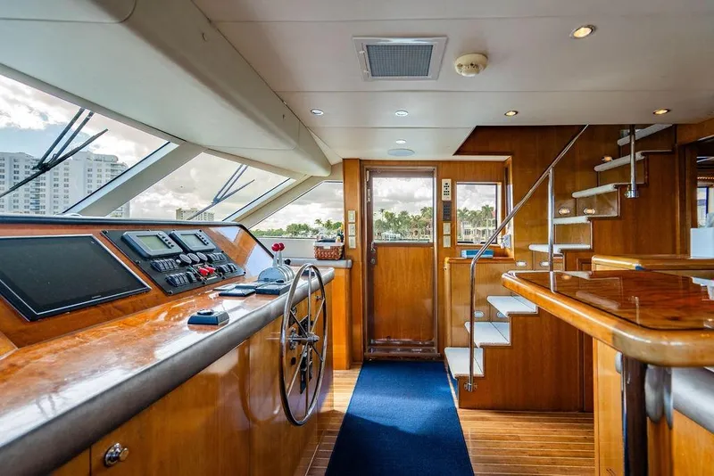 Slide: The Image of Interior of 2003 Hatteras 75' Cockpit MY yacht with helm and wooden staircase. - 9