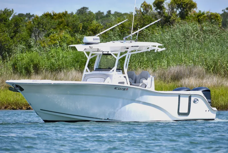 The Image of 2020 Sea Fox 288 Commander boat on water, surrounded by lush greenery. - 0