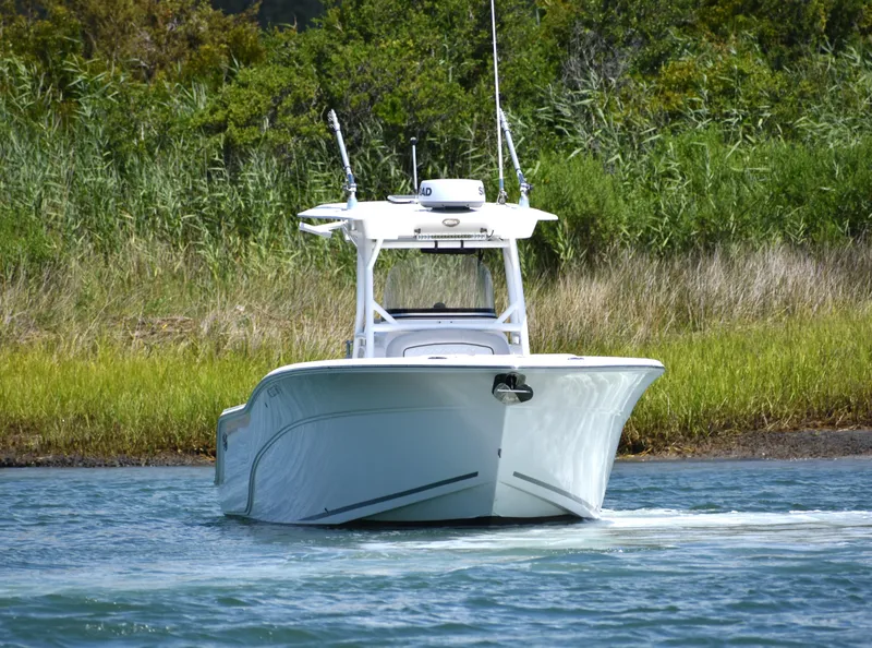 Slide: The Image of 2020 Sea Fox 288 Commander boat navigating through calm waters near lush greenery. - 10