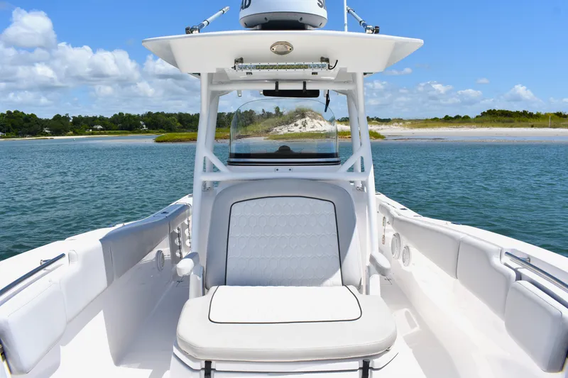 Slide: The Image of 2020 Sea Fox 288 Commander boat on calm water with scenic shoreline background. - 17