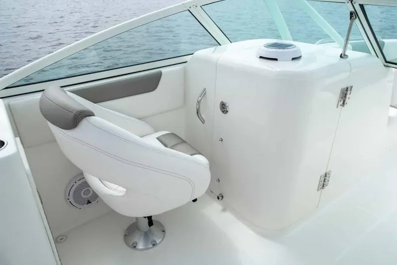 Slide: The Image of Manufacturer Provided Image: 2026 World Cat 230 SD boat interior with white seating and console, on calm water. - 14