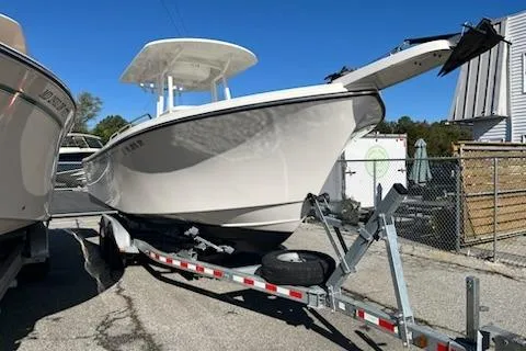 The Image of 2020 Parker 2501 Center Console boat on trailer, parked outdoors under clear blue sky. - 0