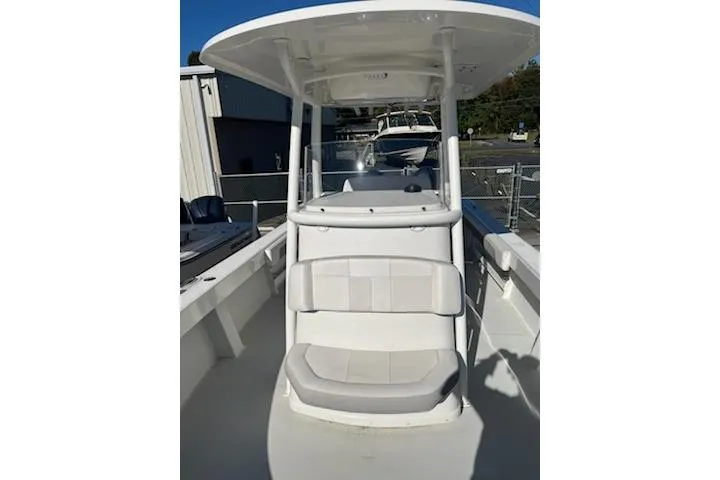 Slide: The Image of 2020 Parker 2501 Center Console boat with seating and T-top in a marina setting. - 10