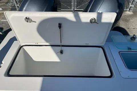 Slide: The Image of 2020 Parker 2501 Center Console boat with open storage compartment. - 12