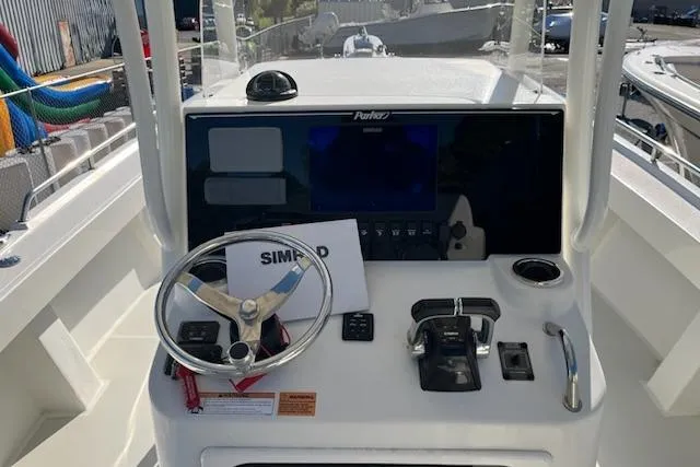 Slide: The Image of 2020 Parker 2501 Center Console boat dashboard with steering wheel and controls. - 14