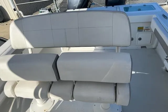 Slide: The Image of 2020 Parker 2501 Center Console boat seating area with white cushioned seats. - 16