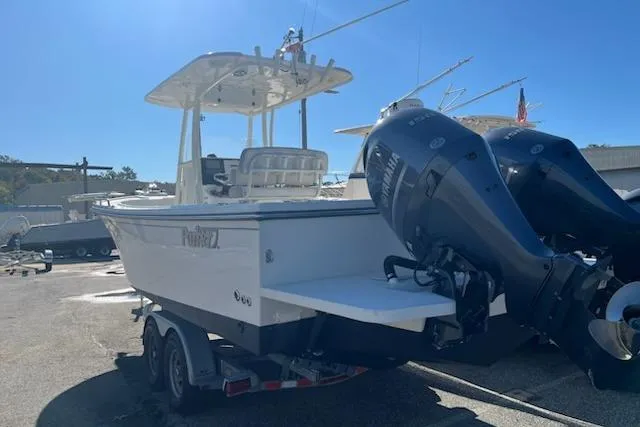 Slide: The Image of 2020 Parker 2501 Center Console boat with dual outboard motors on a trailer. - 2