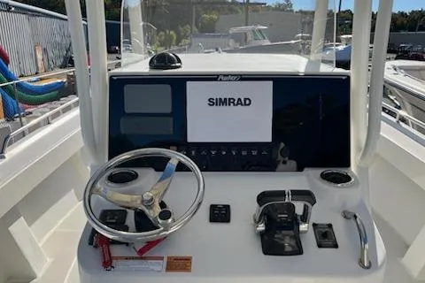 Slide: The Image of 2020 Parker 2501 Center Console boat dashboard with Simrad navigation system. - 6