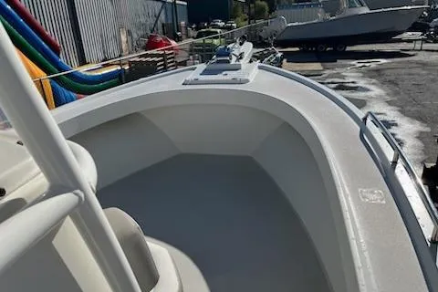 Slide: The Image of 2020 Parker 2501 Center Console boat in a marina, showcasing its spacious deck. - 8