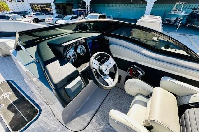 Slide: The Image of 2026 Harris Solstice DC 250 boat dashboard with modern steering and controls. - 14