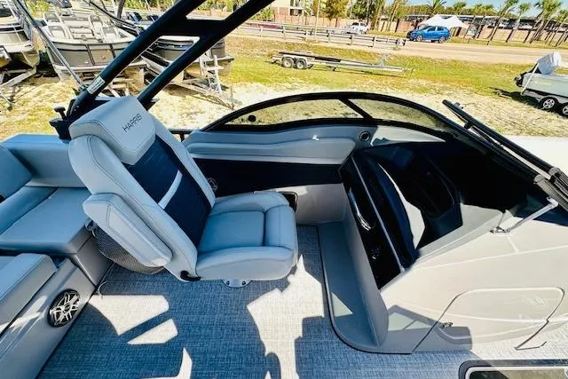 Slide: The Image of 2026 Harris Solstice DC 250 boat interior with modern seating and sleek dashboard design. - 16