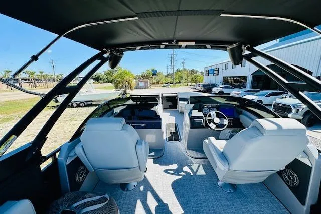 Slide: The Image of 2026 Harris Solstice DC 250 boat interior with modern helm and seating. - 26