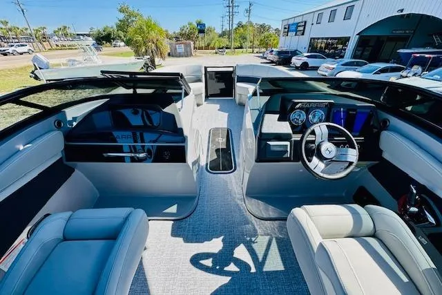 Slide: The Image of Interior view of 2026 Harris Solstice DC 250 boat, featuring modern dashboard and seating. - 27