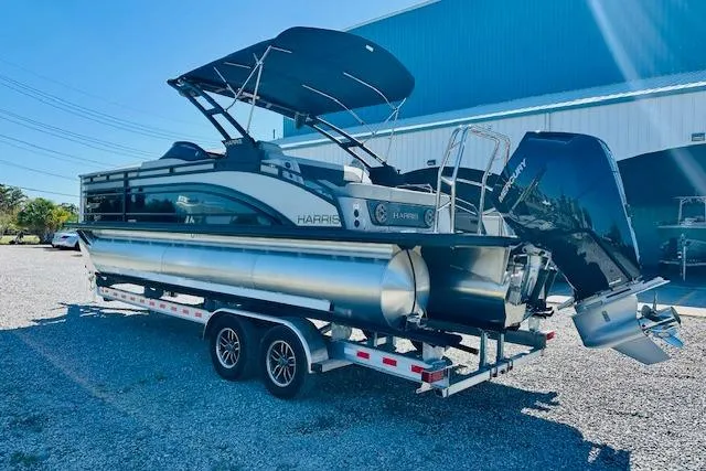 Slide: The Image of 2026 Harris Solstice DC 250 pontoon boat on trailer, parked outdoors. - 3