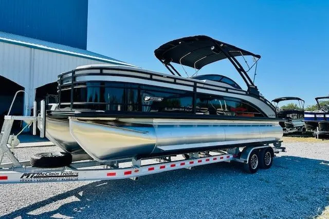 Slide: The Image of 2026 Harris Solstice DC 250 pontoon boat on trailer, parked outdoors. - 5