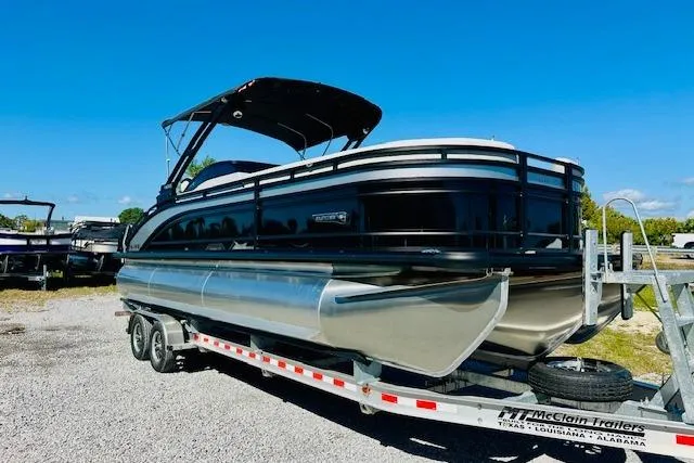 Slide: The Image of 2026 Harris Solstice DC 250 pontoon boat on trailer under clear blue sky. - 7
