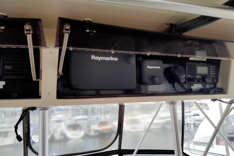 Slide: The Image of 1988 Viking 48 Convertible boat dashboard with Raymarine navigation equipment. - 12