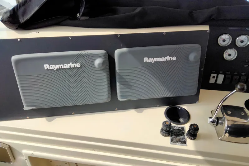 Slide: The Image of Control panel of 1988 Viking 48 Convertible with Raymarine equipment and gauges. - 6