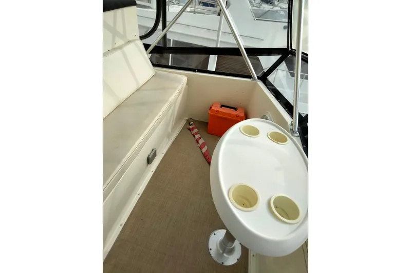 Slide: The Image of Interior of 1988 Viking 48 Convertible boat with seating and cup holders. - 7