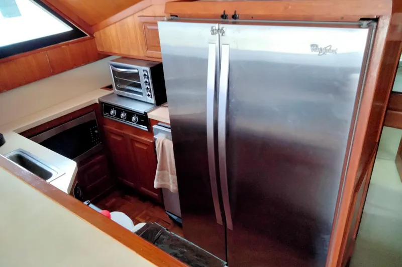 Slide: The Image of Galley kitchen in 1988 Viking 48 Convertible yacht with stainless steel appliances. - 9