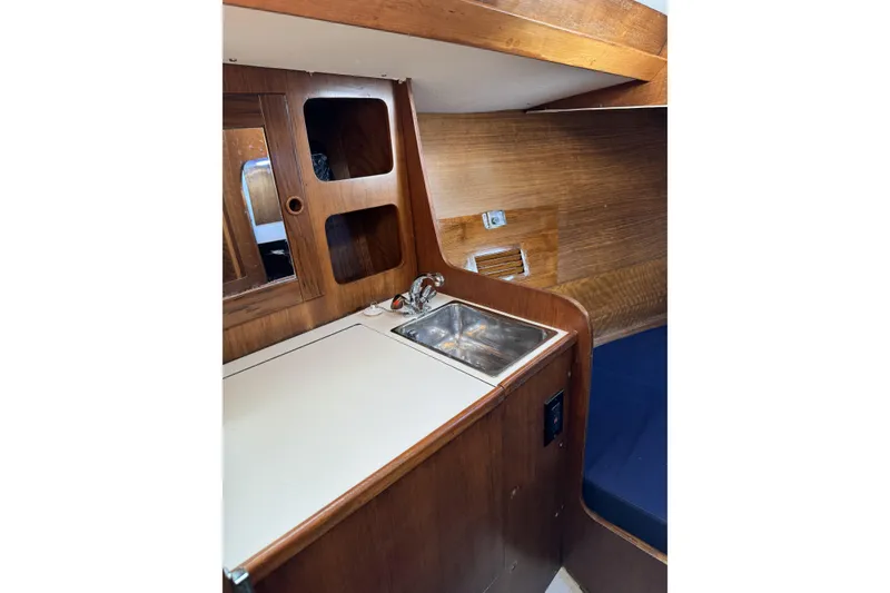 Slide: The Image of 1984 Barberis 38 yacht interior with wooden cabinetry and compact sink area. - 13