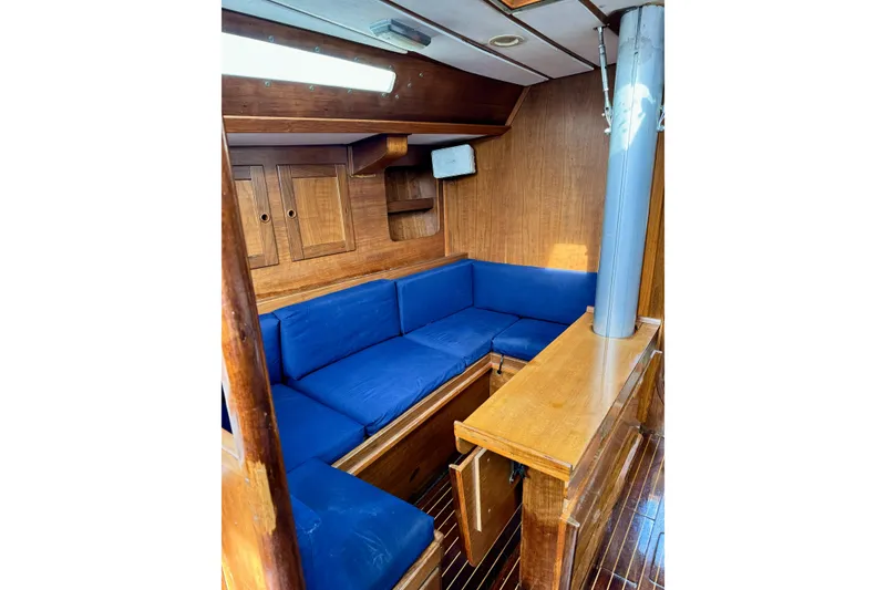 Slide: The Image of Interior of 1984 Barberis 38 sailboat with blue cushions and wooden cabinetry. - 16