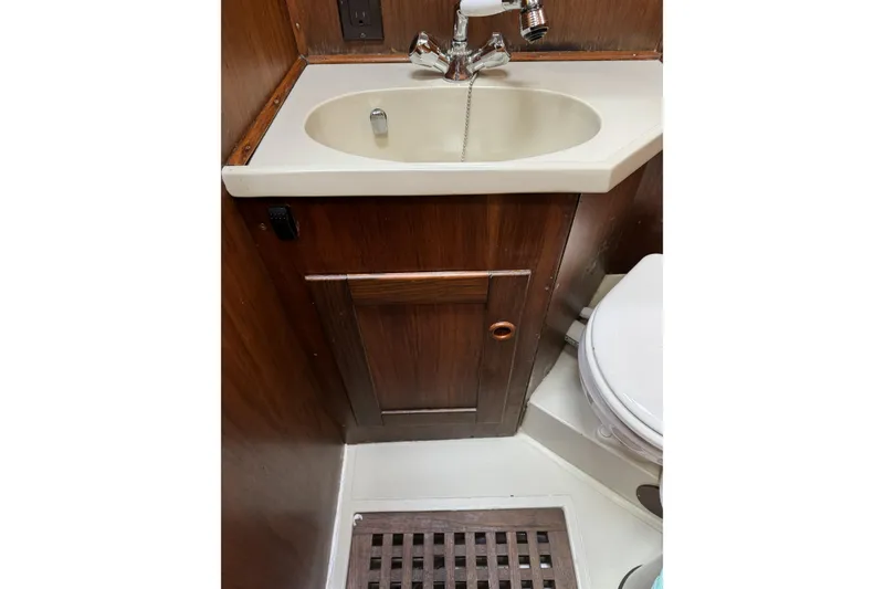 Slide: The Image of 1984 Barberis 38 yacht bathroom with wooden cabinetry, sink, and toilet. - 22
