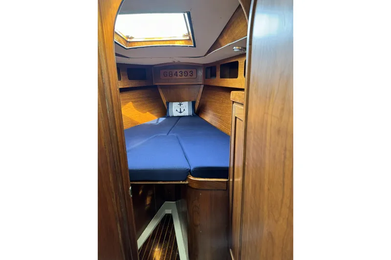 Slide: The Image of Cozy cabin interior of 1984 Barberis 38 sailboat with blue bedding and wooden finish. - 23