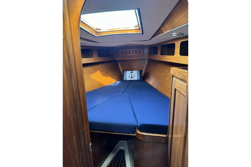 Slide: The Image of Interior cabin of 1984 Barberis 38 sailboat with blue cushions and wooden finish. - 24